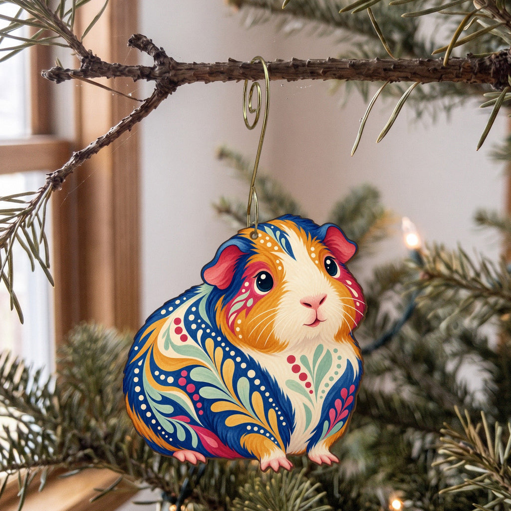 Laser-cut maple wood Guinea Pig folk art ornament O469 hanging on a fir branch, made in USA