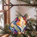 Laser-cut maple wood Guinea Pig folk art ornament O469 hanging on a fir branch, made in USA