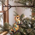 Laser-cut maple wood Ferret folk art ornament O474 hanging on a fir branch, made in USA