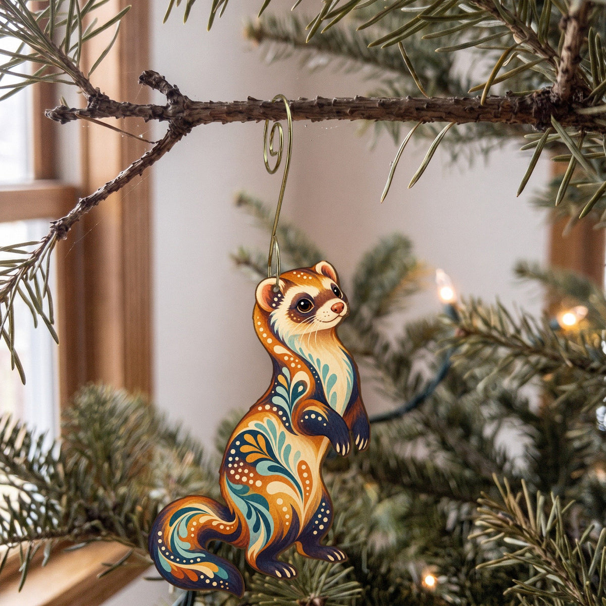 Laser-cut maple wood Ferret folk art ornament O474 hanging on a fir branch, made in USA