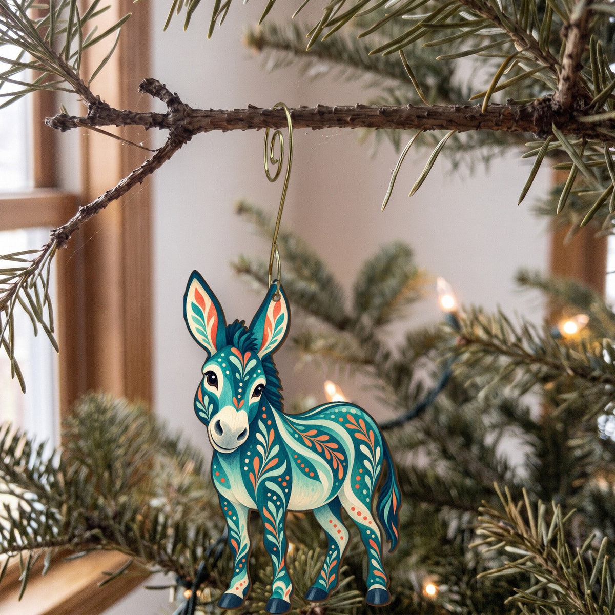 Laser-cut maple wood Donkey folk art ornament O481 hanging on a fir branch, made in USA