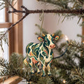 Laser-cut maple wood Holstein Cow folk art ornament O483 hanging on a fir branch, made in USA