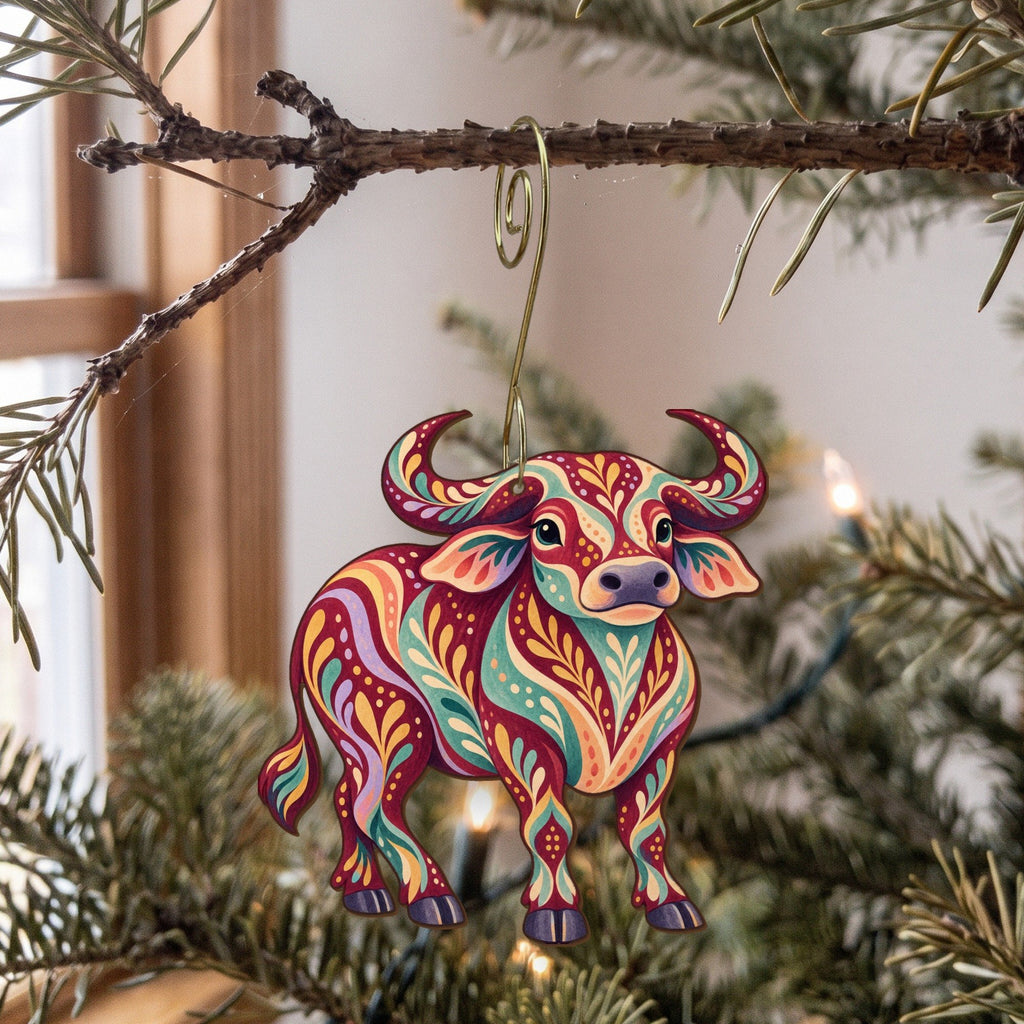 Laser-cut maple wood Water Buffalo folk art ornament O486 hanging on a fir branch, made in USA