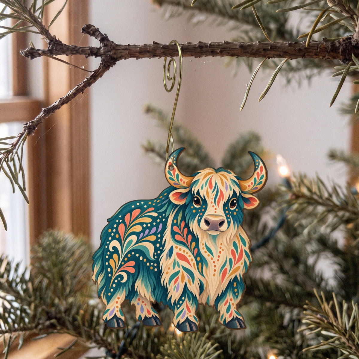 Laser-cut maple wood Domestic Yak folk art ornament O487 hanging on a fir branch, made in USA