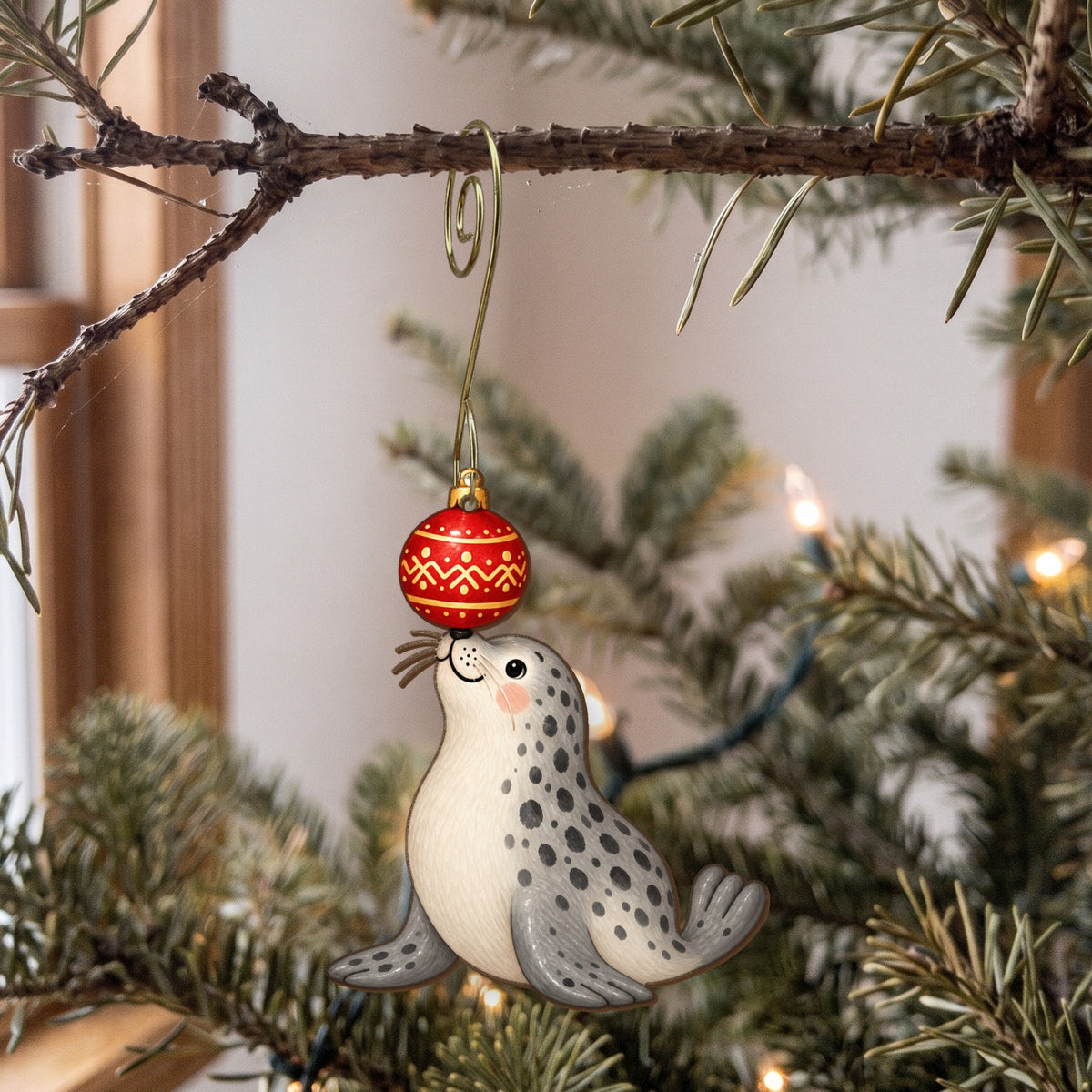 Laser-cut maple wood Christmas ornament O48 hanging on a fir branch, made in USA