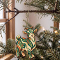 Laser-cut maple wood Pygmy Goat folk art ornament O491 hanging on a fir branch, made in USA
