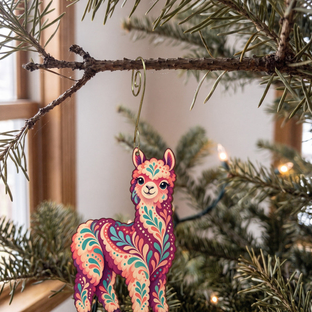 Laser-cut maple wood Alpaca folk art ornament O492 hanging on a fir branch, made in USA