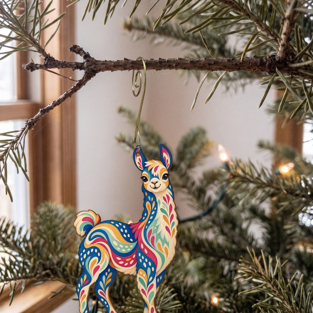 Laser-cut maple wood Llama folk art ornament O493 hanging on a fir branch, made in USA