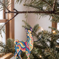 Laser-cut maple wood Llama folk art ornament O493 hanging on a fir branch, made in USA