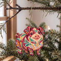 Laser-cut maple wood Kunekune Pig folk art ornament O494 hanging on a fir branch, made in USA