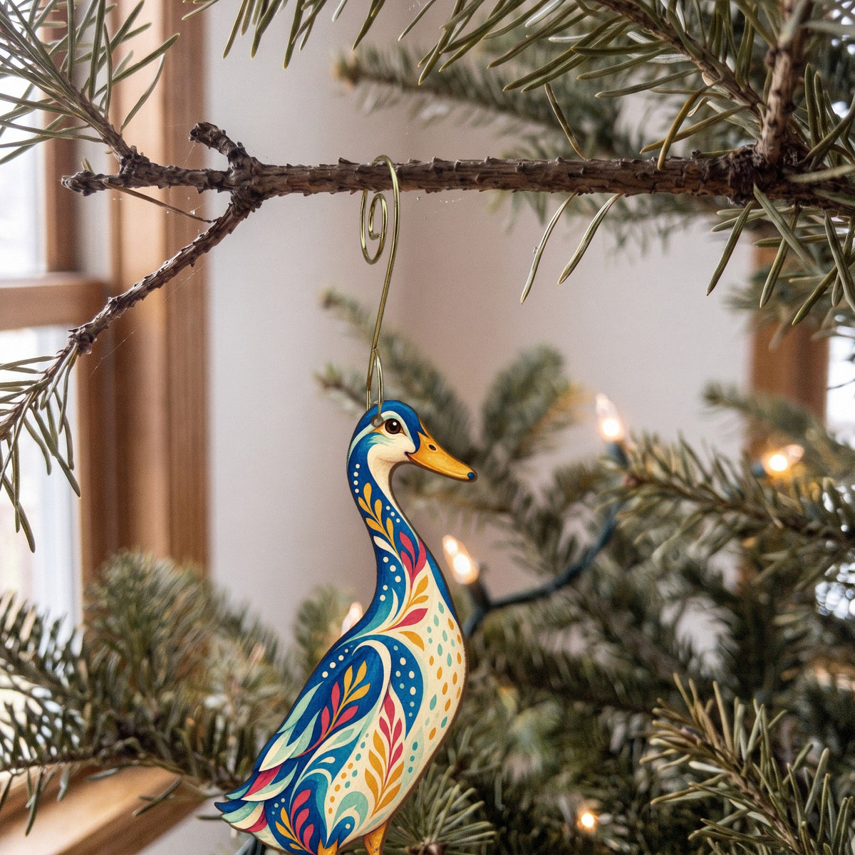 Laser-cut maple wood Indian Runner Duck folk art ornament O501 hanging on a fir branch, made in USA
