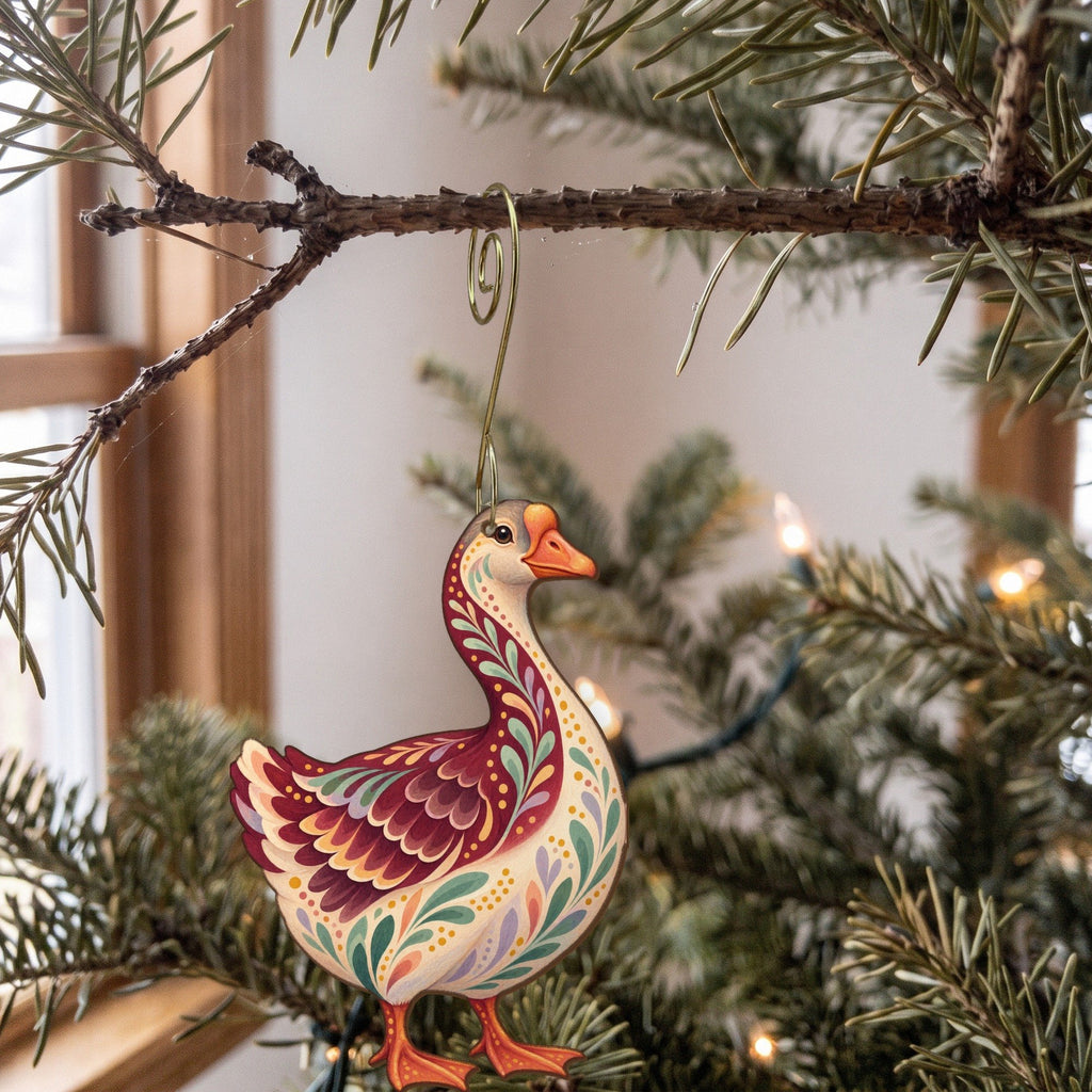 Laser-cut maple wood Toulouse Goose folk art ornament O502 hanging on a fir branch, made in USA