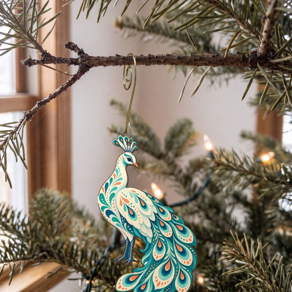 Laser-cut maple wood White Peacock folk art ornament O505 hanging on a fir branch, made in USA