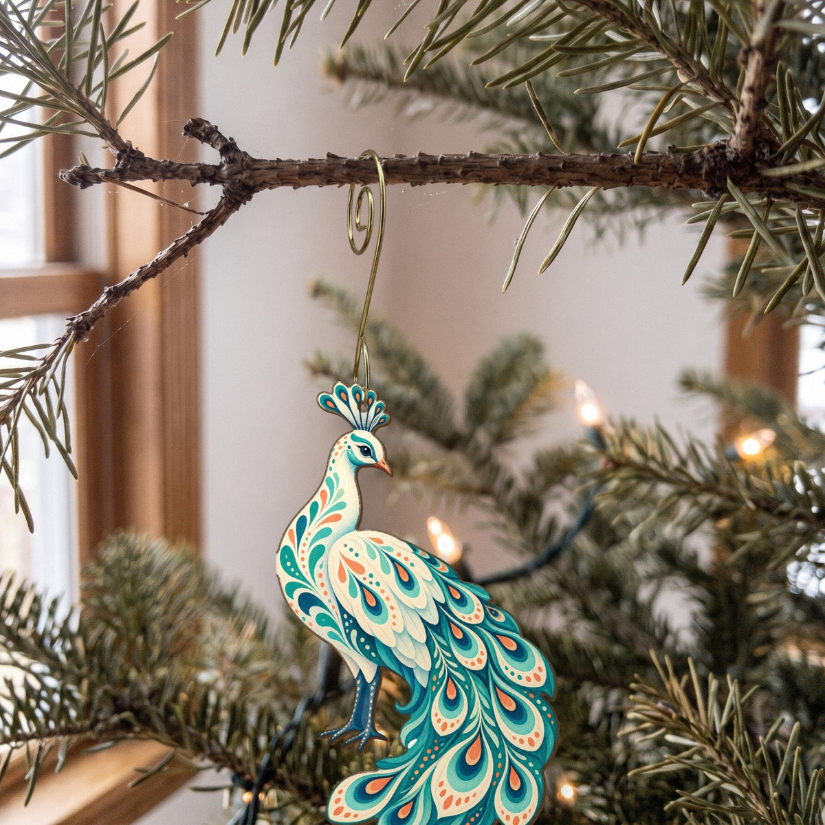 Laser-cut maple wood White Peacock folk art ornament O505 hanging on a fir branch, made in USA