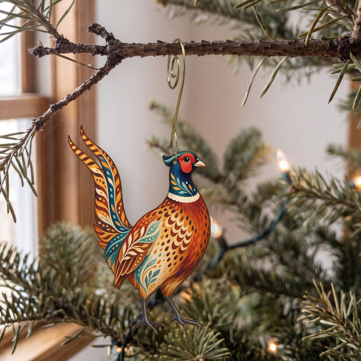 Laser-cut maple wood Ring-Necked Pheasant folk art ornament O506 hanging on a fir branch, made in USA