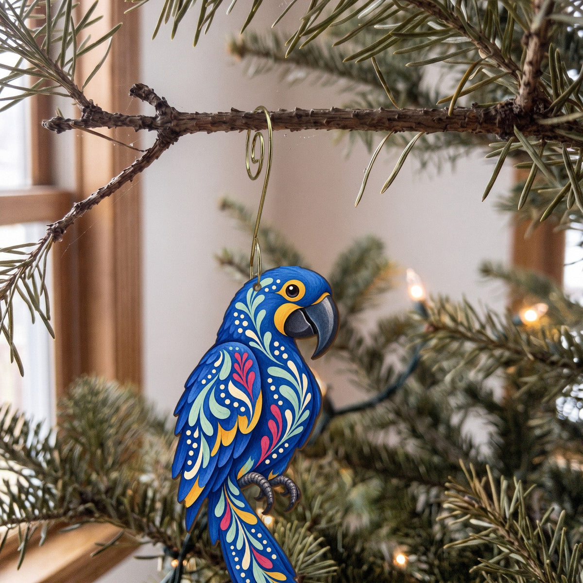 Laser-cut maple wood Hyacinth Macaw folk art ornament O509 hanging on a fir branch, made in USA
