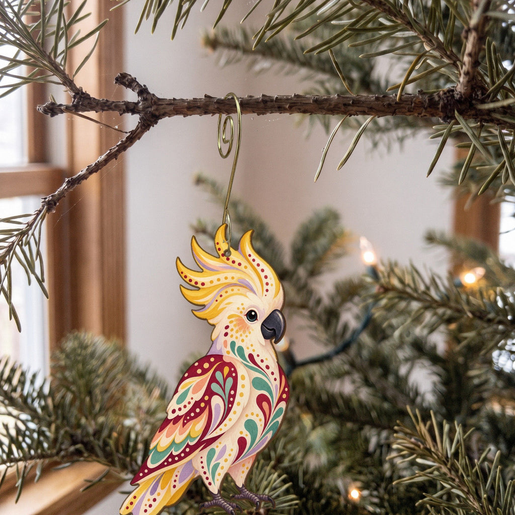 Laser-cut maple wood Sulphur-Crested Cockatoo folk art ornament O510 hanging on a fir branch, made in USA