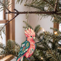Laser-cut maple wood Galah Cockatoo folk art ornament O511 hanging on a fir branch, made in USA