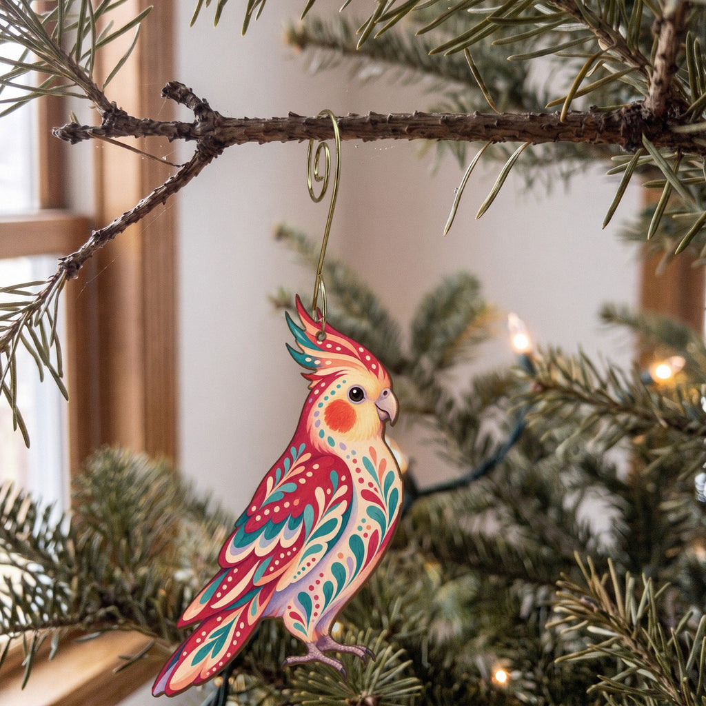 Laser-cut maple wood Cockatiel folk art ornament O512 hanging on a fir branch, made in USA
