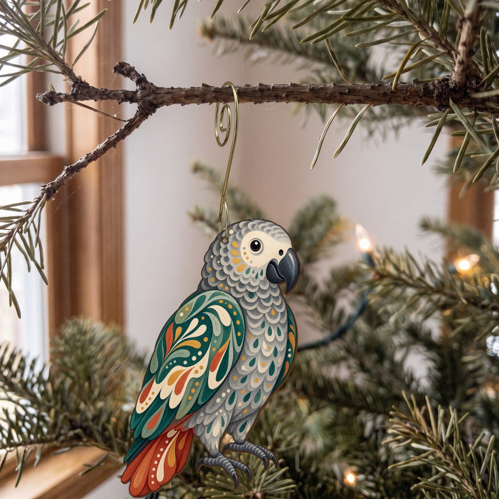 Laser-cut maple wood African Gray Parrot folk art ornament O515 hanging on a fir branch, made in USA