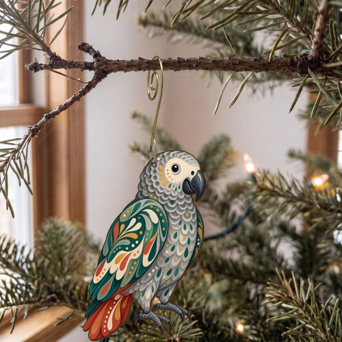 Laser-cut maple wood African Gray Parrot folk art ornament O515 hanging on a fir branch, made in USA