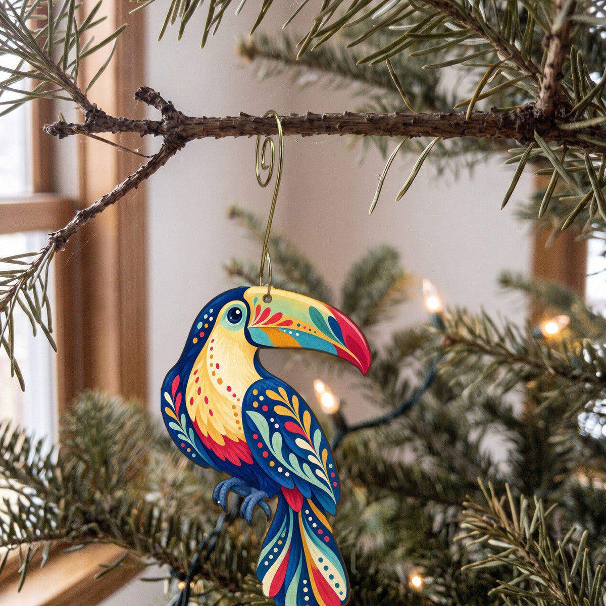 Laser-cut maple wood Keel-Billed Toucan folk art ornament O517 hanging on a fir branch, made in USA