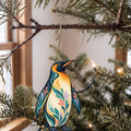 Laser-cut maple wood King Penguin folk art ornament O519 hanging on a fir branch, made in USA