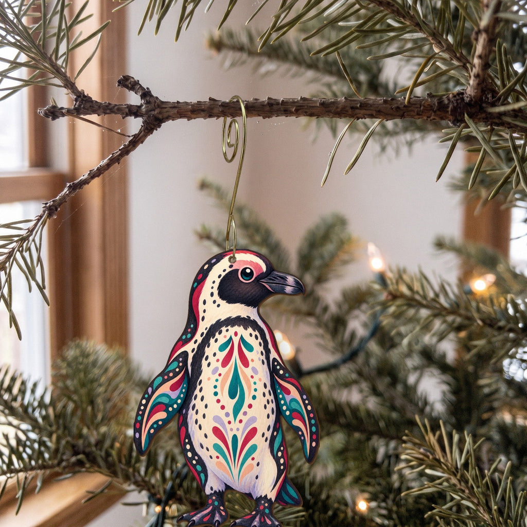 Laser-cut maple wood African Penguin folk art ornament O520 hanging on a fir branch, made in USA