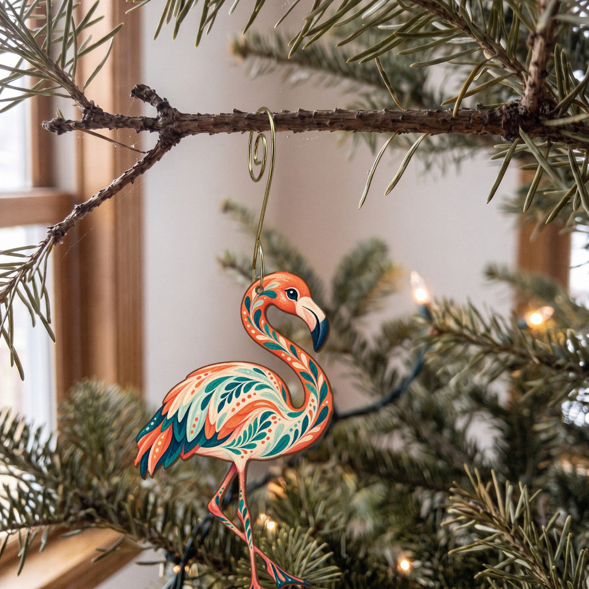 Laser-cut maple wood Chilean Flamingo folk art ornament O521 hanging on a fir branch, made in USA