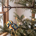Laser-cut maple wood Ostrich folk art ornament O522 hanging on a fir branch, made in USA