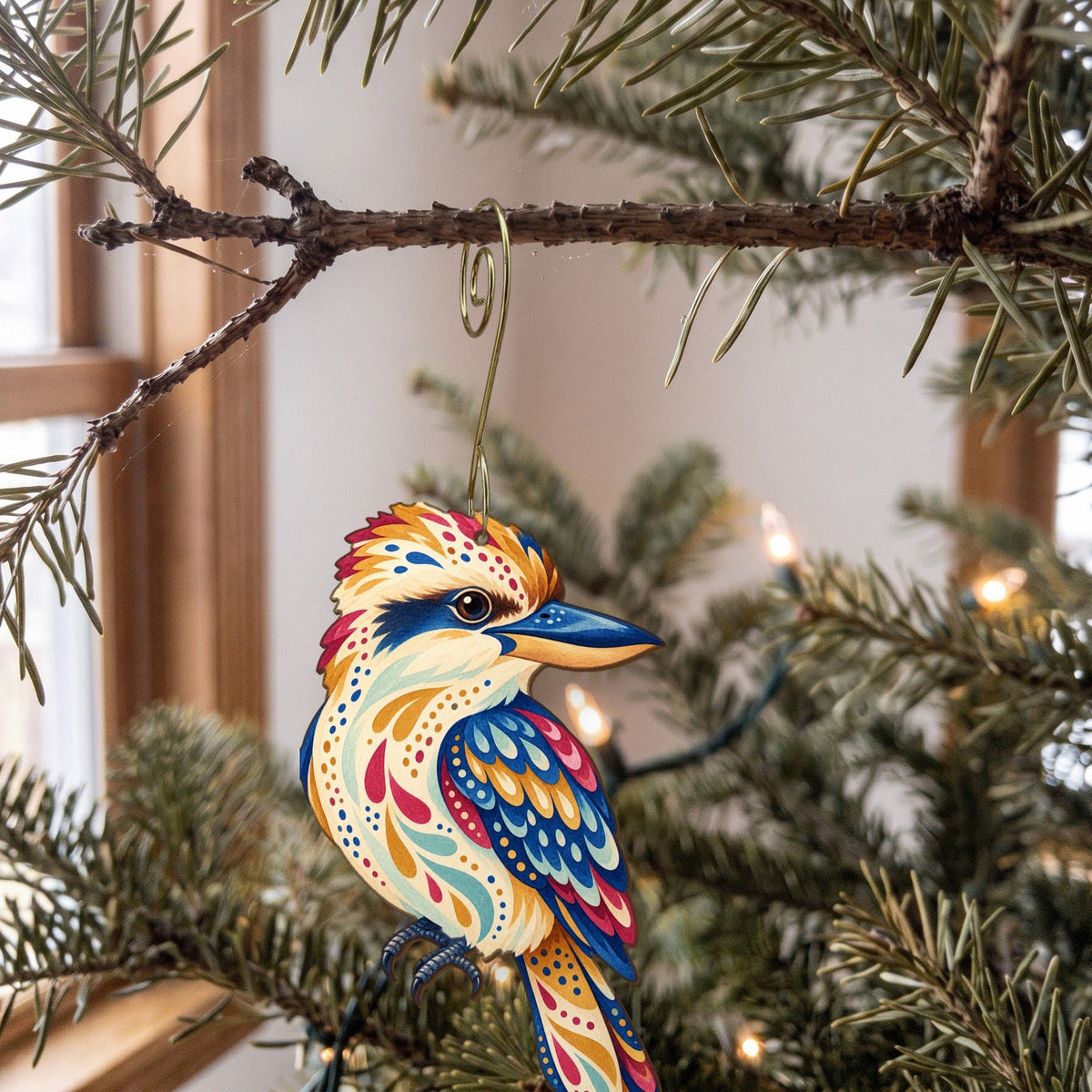 Laser-cut maple wood Kookaburra folk art ornament O525 hanging on a fir branch, made in USA