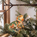 Laser-cut maple wood Bearded Dragon folk art ornament O531 hanging on a fir branch, made in USA