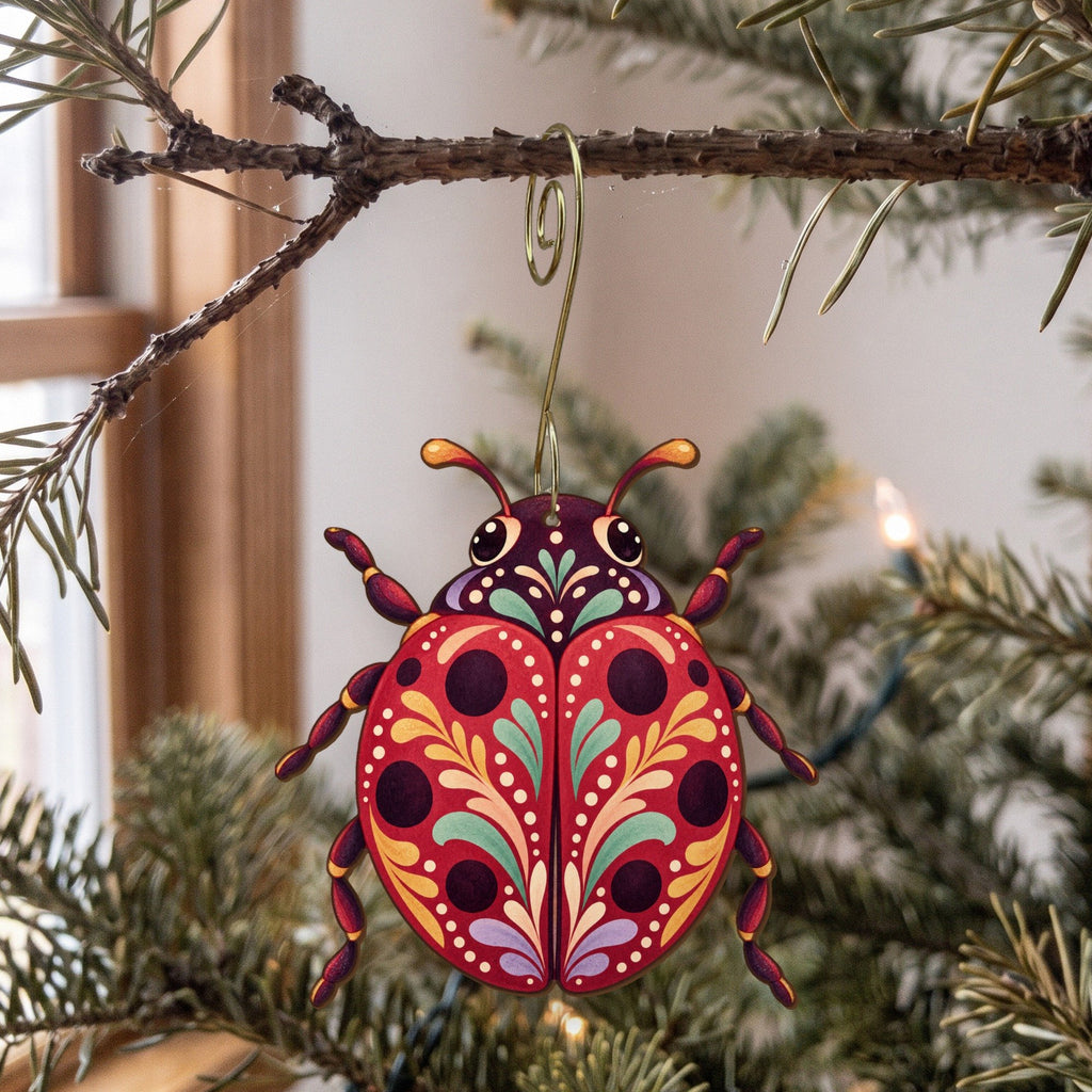 Laser-cut maple wood Ladybug folk art ornament O534 hanging on a fir branch, made in USA