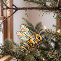 Laser-cut maple wood Honeybee folk art ornament O535 hanging on a fir branch, made in USA