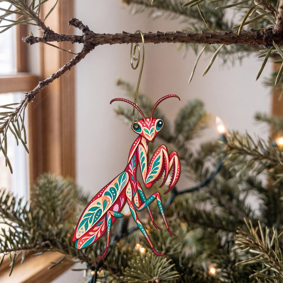 Laser-cut maple wood Praying Mantis folk art ornament O536 hanging on a fir branch, made in USA