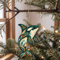 Laser-cut maple wood Orca folk art ornament O91 hanging on a fir branch, made in USA