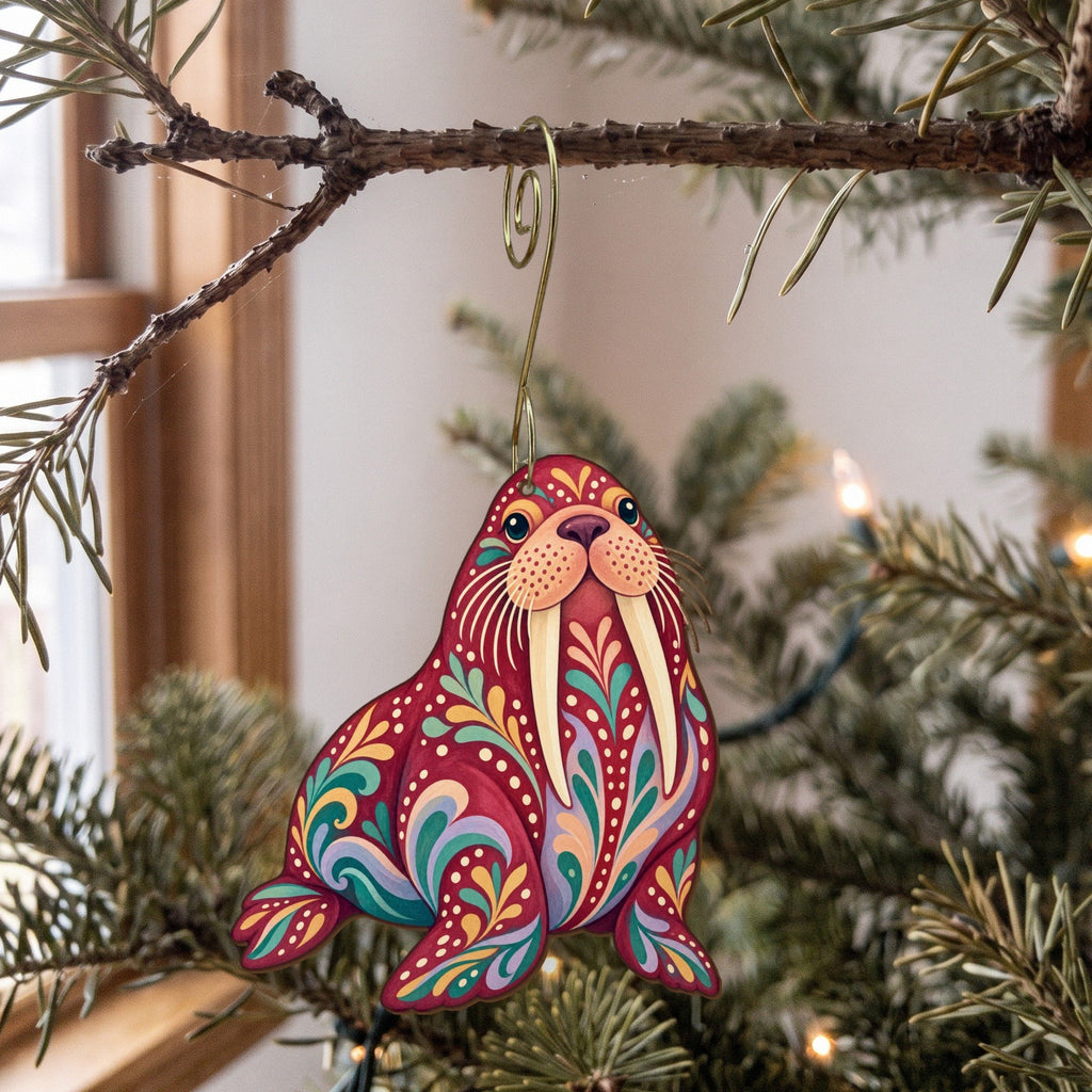 Laser-cut maple wood Walrus folk art ornament O94 hanging on a fir branch, made in USA