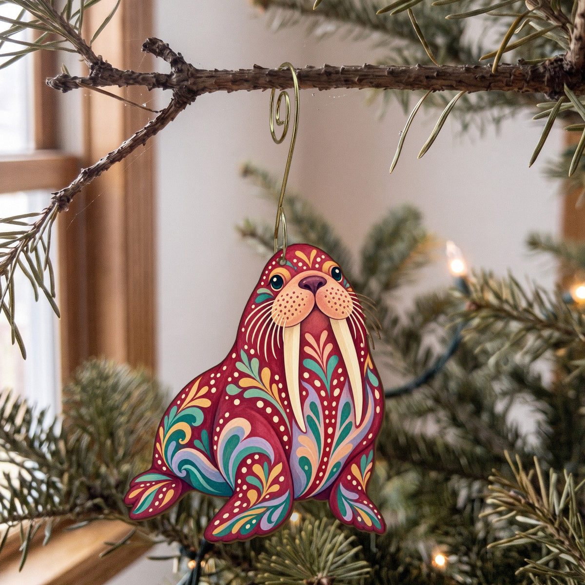 Laser-cut maple wood Walrus folk art ornament O94 hanging on a fir branch, made in USA