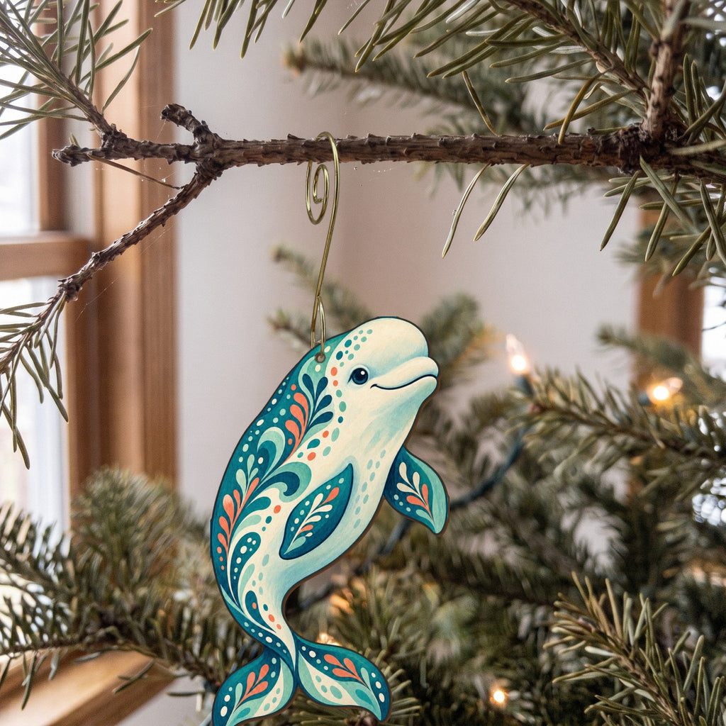 Laser-cut maple wood Beluga Whale folk art ornament O97 hanging on a fir branch, made in USA