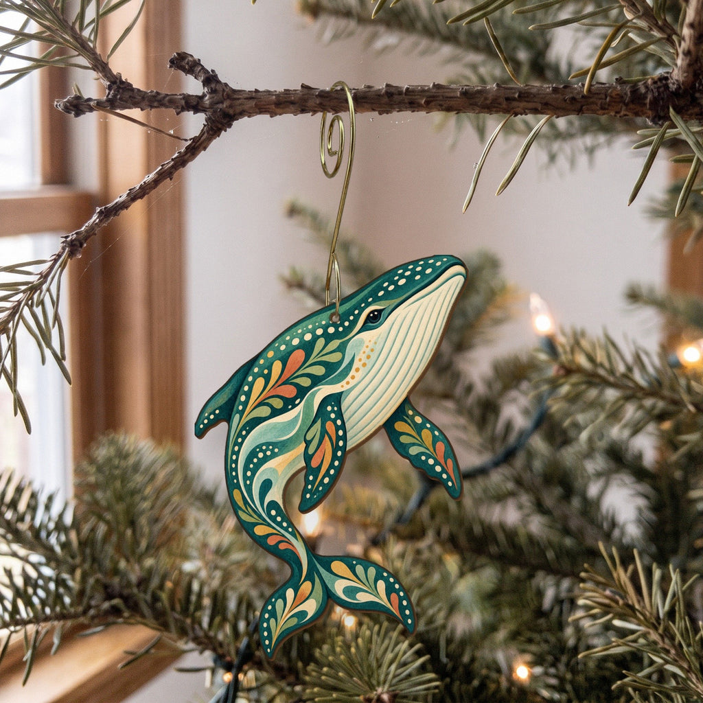 Laser-cut maple wood Blue Whale folk art ornament O99 hanging on a fir branch, made in USA